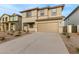 Two-story house with a beige exterior, two-car garage, and landscaping at 31751 N Velvet Rush Rd, San Tan Valley, AZ 85143
