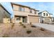 Two-story house with a beige exterior, two-car garage, and landscaping at 31751 N Velvet Rush Rd, San Tan Valley, AZ 85143