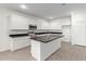 Modern kitchen with island, stainless steel appliances, and white cabinetry at 31751 N Velvet Rush Rd, San Tan Valley, AZ 85143