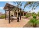 Outdoor patio area with pergola, seating, and dining table at 28694 N 127Th Ln, Peoria, AZ 85383