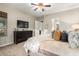 Main bedroom with a king bed, dresser, and TV at 28694 N 127Th Ln, Peoria, AZ 85383