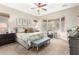 Spacious main bedroom with plush carpet, large windows, and a ceiling fan at 28694 N 127Th Ln, Peoria, AZ 85383