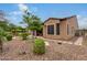 Landscaped backyard with a stone pathway and desert landscaping at 28694 N 127Th Ln, Peoria, AZ 85383