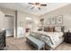 Main bedroom features a king-size bed, ensuite bathroom access, and ample natural light at 28694 N 127Th Ln, Peoria, AZ 85383
