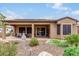 Covered patio with a dining table and seating area at 28694 N 127Th Ln, Peoria, AZ 85383