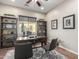 Home office with built-in shelving and a large work desk at 28694 N 127Th Ln, Peoria, AZ 85383