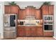 Well-equipped kitchen with stainless steel appliances and rich wood cabinets at 28694 N 127Th Ln, Peoria, AZ 85383