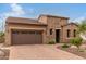 Craftsman style home with stone accents and a two car garage at 28694 N 127Th Ln, Peoria, AZ 85383