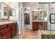 Elegant bathroom with double vanities, large walk-in shower, and ample closet space at 28694 N 127Th Ln, Peoria, AZ 85383