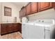 Laundry room with washer, dryer, and upper cabinets at 28694 N 127Th Ln, Peoria, AZ 85383