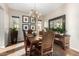 Elegant dining room with a rustic wood table and chandelier at 28694 N 127Th Ln, Peoria, AZ 85383