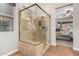 Large walk-in shower with glass enclosure, tile surround, and built-in seat at 28694 N 127Th Ln, Peoria, AZ 85383