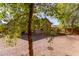 Large backyard with gravel and mature trees at 26058 W Yukon Dr, Buckeye, AZ 85396