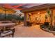 Evening view of a relaxing patio with comfortable seating and outdoor kitchen at 33231 N 72Nd Pl, Scottsdale, AZ 85266