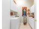 Laundry room with washer, dryer and overhead cabinets at 33231 N 72Nd Pl, Scottsdale, AZ 85266