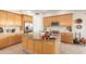 Modern kitchen with light wood cabinets, granite island, and stainless steel appliances at 33231 N 72Nd Pl, Scottsdale, AZ 85266