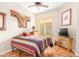 Bedroom with striped bedding and a flat screen TV at 33231 N 72Nd Pl, Scottsdale, AZ 85266