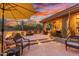 Outdoor patio with seating area, steps leading down, and stunning sunset views at 33231 N 72Nd Pl, Scottsdale, AZ 85266