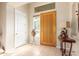 Bright entryway with wood door, tile floors, and southwestern decor at 33231 N 72Nd Pl, Scottsdale, AZ 85266