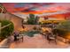 Inviting backyard pool with patio furniture and sunset backdrop at 33231 N 72Nd Pl, Scottsdale, AZ 85266