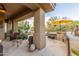 Large covered patio with comfortable seating, an outdoor kitchen, and a beautiful view at 33231 N 72Nd Pl, Scottsdale, AZ 85266