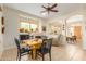 Open dining area with a wooden table and chairs, offering views into adjacent rooms at 33231 N 72Nd Pl, Scottsdale, AZ 85266