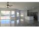 Open concept living room with kitchen and tile flooring at 27824 N 256Th Ave, Wittmann, AZ 85361