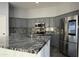 Modern kitchen with gray cabinets and granite countertops at 27824 N 256Th Ave, Wittmann, AZ 85361