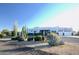View of the front of a beautiful white stucco home with desert landscaping at 27824 N 256Th Ave, Wittmann, AZ 85361