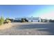 White stucco house with a three-car garage and desert landscaping at 27824 N 256Th Ave, Wittmann, AZ 85361
