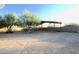 Large backyard with covered structure and mature trees at 27824 N 256Th Ave, Wittmann, AZ 85361