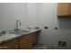 Laundry room with utility sink and cabinets at 27824 N 256Th Ave, Wittmann, AZ 85361