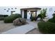 Front entrance with walkway, fountain, and lush landscaping at 27824 N 256Th Ave, Wittmann, AZ 85361