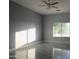 Spacious bedroom with large window and tile floors at 27824 N 256Th Ave, Wittmann, AZ 85361