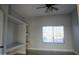 Bright bedroom with built-in shelves and large window at 27824 N 256Th Ave, Wittmann, AZ 85361