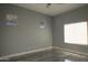 Bright bedroom with two windows and tile floors at 27824 N 256Th Ave, Wittmann, AZ 85361