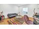 Home office with colorful rug, gray couch, and plenty of natural light at 7240 N 13Th Ln, Phoenix, AZ 85021