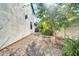 Side yard with gravel landscaping and two metal chairs at 7240 N 13Th Ln, Phoenix, AZ 85021