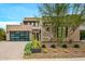 Modern home with stone and stucco exterior, attached garage, and desert landscaping at 37200 N Cave Creek Rd # 1082, Scottsdale, AZ 85262