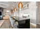 Modern kitchen with white cabinets, black countertops, and a large island with seating at 37200 N Cave Creek Rd # 1082, Scottsdale, AZ 85262