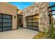 Modern home with stone and stucco exterior, attached garage, and desert landscaping at 37200 N Cave Creek Rd # 1082, Scottsdale, AZ 85262