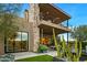 Two-story home with stone exterior and large patio at 37200 N Cave Creek Rd # 1082, Scottsdale, AZ 85262