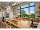 Bright dining room with large windows and a live-edge wood table at 37200 N Cave Creek Rd # 1082, Scottsdale, AZ 85262