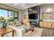 Bright living room with a large TV, comfortable seating, and modern fireplace at 37200 N Cave Creek Rd # 1082, Scottsdale, AZ 85262