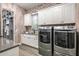 Bright laundry room with washer, dryer and built-in storage at 37200 N Cave Creek Rd # 1082, Scottsdale, AZ 85262