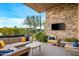 Relaxing patio with sectional sofa and stone wall at 37200 N Cave Creek Rd # 1082, Scottsdale, AZ 85262