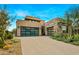 Modern home with stone and stucco exterior, attached garage, and desert landscaping at 37200 N Cave Creek Rd # 1082, Scottsdale, AZ 85262