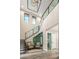 Elegant staircase with glass railings and a wine cellar feature at 37200 N Cave Creek Rd # 1082, Scottsdale, AZ 85262