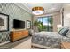 Bedroom with geometric wallpaper and private access to the backyard at 37200 N Cave Creek Rd # 1082, Scottsdale, AZ 85262