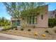 Modern home with stone and stucco exterior, attached garage, and desert landscaping at 37200 N Cave Creek Rd # 1082, Scottsdale, AZ 85262